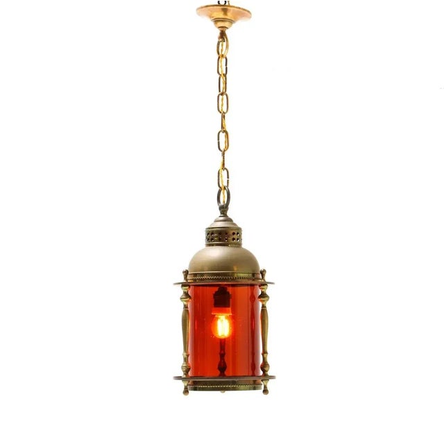 Stunning Art Nouveau hall lantern. Striking Dutch design from the 1900s. Patinated brass frame with original glass shade....