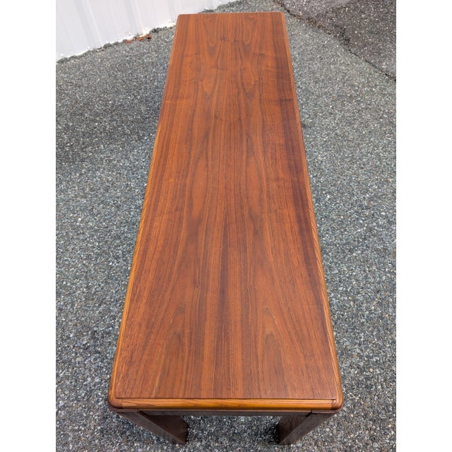 This elegant Lane walnut console sofa table combines sleek Mid-Century Modern architecture with timeless craftsmanship....