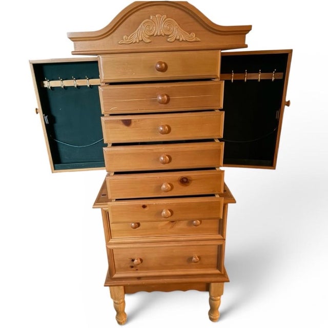 A beautifully crafted Fontana jewelry armoire with a warm honey wood finish and refined traditional detailing. The piece...