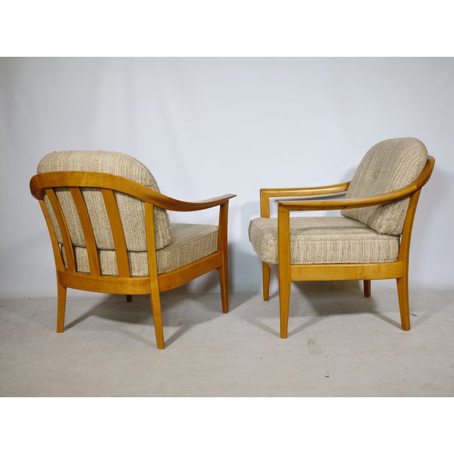 Two club chairs by Klaus Warzecha for Wilhelm Knoll from the 1970s. Cherry wood frame with curved armrests and upholstered...
