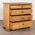 Antique pine chest of four drawers resting on bun feet. Gentle curves/carving to top drawer, dove-tail joints and brass...