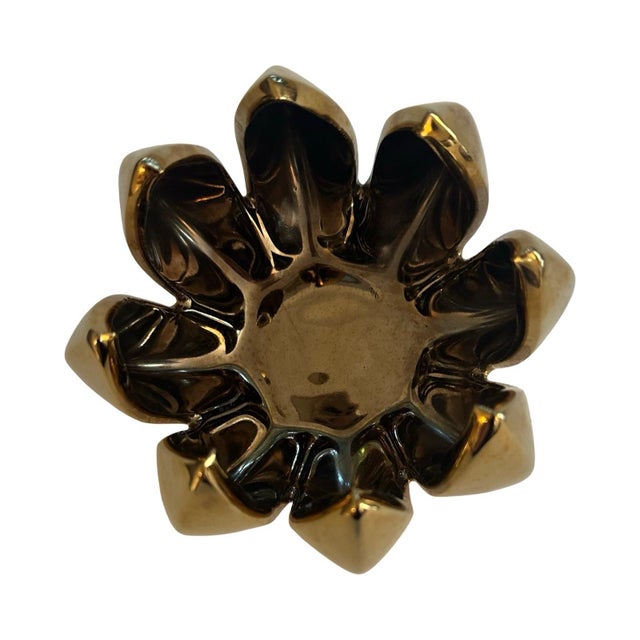 This sculptural piece is made of ceramic with a high-gloss metallic glaze with warm gold on the outside and deep bronze...