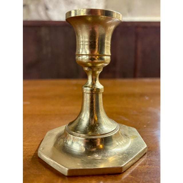This is a vintage classic brass candlestick holder featuring a traditional Colonial-inspired silhouette with an elegant...