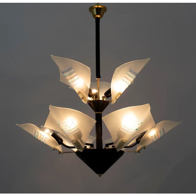 Chandelier composed of nine Murano glass in the shape of sails, the structure is in black lacquered metal and brass. Nine...