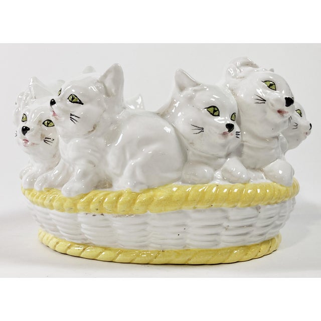 Whimsical vintage ceramic bowl featuring cluster of ten white cats in a white and yellow trimmed wicker basket. Marked...