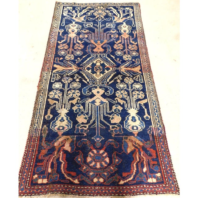 Central medallion surrounded by geometric and floral motifs on a blue background. Natural variation in color due to...