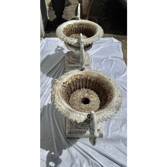 For sale are a pair of rare marked "C. E. Walbridge" cast iron planters/urns, each with a pair of heavy scrolled arms....