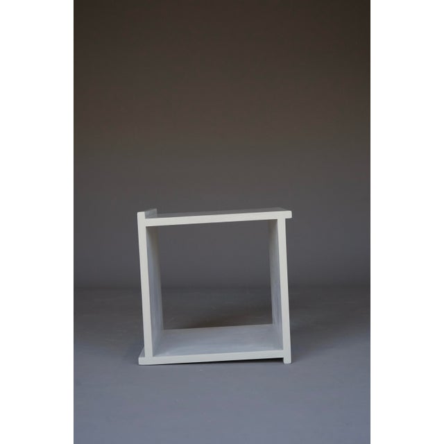 A simple minimalist cube stool in the style of Donald Judd or Gerrit Rietveld.