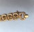 1974 textured goldtone link bracelet with fold over clasp and security chain. Marked "MONET©" on the back of the clasp and...