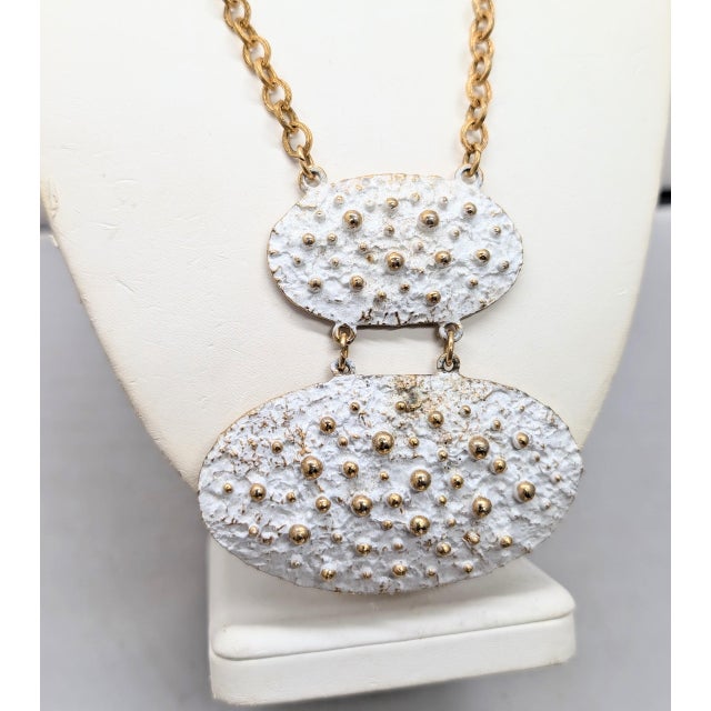 1972 Modernist goldtone two oval graduated bumpy white enameled pendants on a chain necklace with spring ring clasp....
