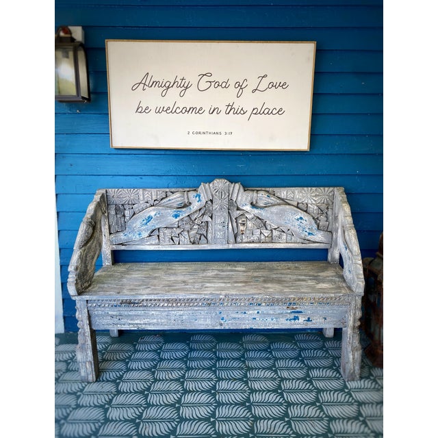 A wonderfully sculptural vintage hand-carved teak bench from Indonesia, featuring an extraordinary backrest with opposing...