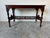 A beautifully crafted vintage Chinese console table made from solid mahogany, showcasing elegant hand-carved details and...