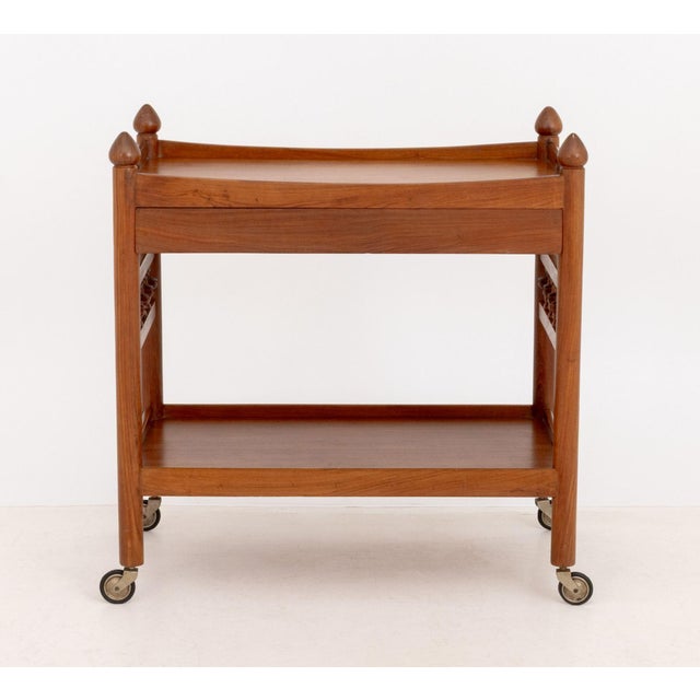 Danish Teak Rolling Tea Trolley, with single drawer the two-handled rectangular top above undertier on four casters....