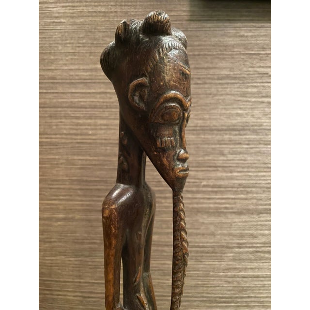 Carved spirit spouses have a long history among the Baule people in Western Africa. This figure, or blolo represented the...