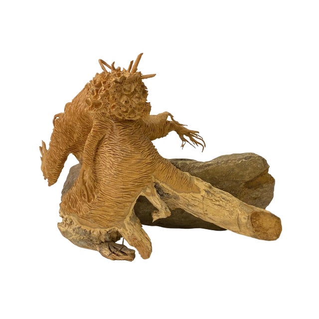 This unique artistic sculpture is carved from a natural wood that is stuck on a heavy stone. The artist uses his...