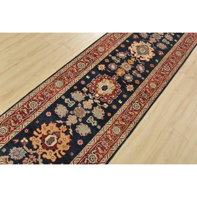 A traditional tribal Caucasian Kazak runner hand-knotted with fine wool on a cotton foundation. This rug features a row of...