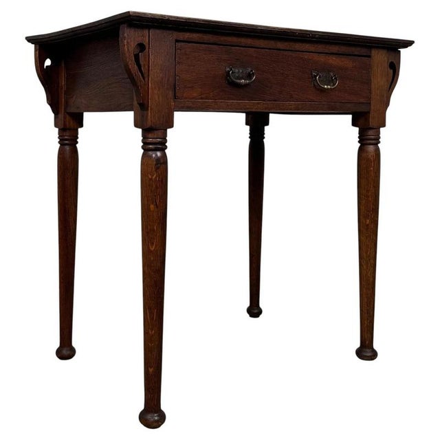 A charming early 20th-century English side table, finely crafted from oak in the Art Nouveau style and distinguished by...