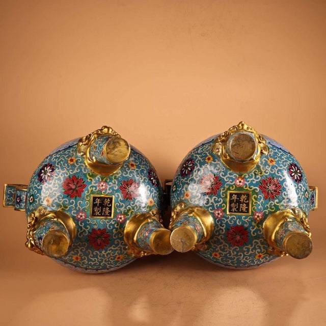 This extraordinary pair of monumental Chinese censers (incense burners) is crafted from copper with vibrant cloisonné...