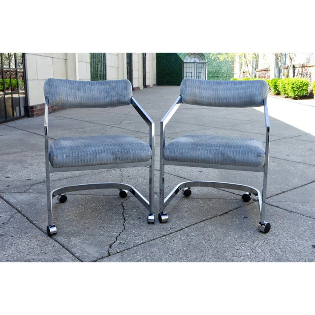 A pair of 1980s chromed metal frame cantilevered chairs on casters attributed to Milo Baughman for Design Institute of...