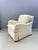 Armchair upholstered in cream velvet with blue piping. Very comfortable. This piece is attributed to the mentioned...