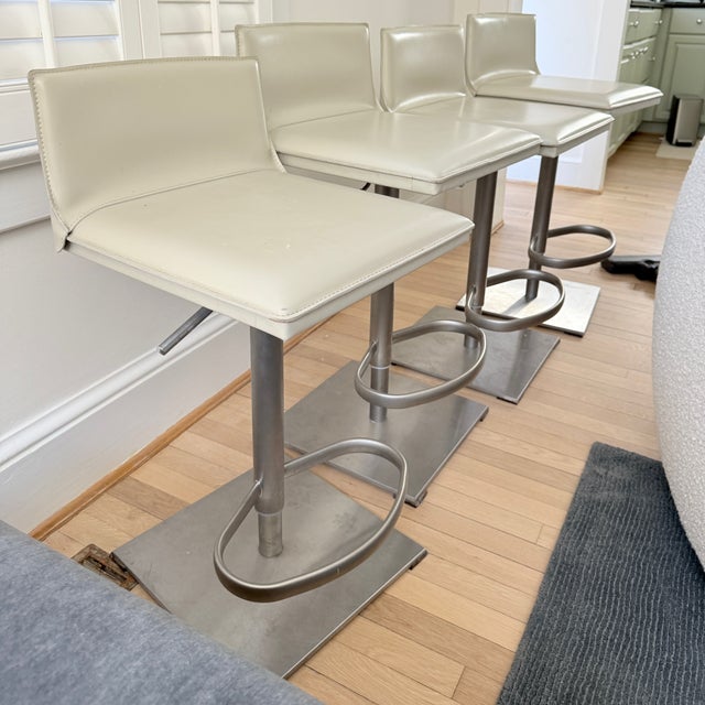 Set of 4 DWR Bottega Piston Stools Bottega Piston Stool swivels 360 degrees and instantly adjusts between counter height...