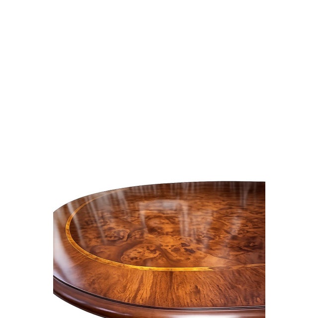 An exceptional large-scale dining table featuring a beautifully figured burl wood top with contrasting decorative inlay...
