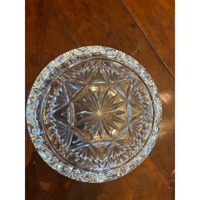 This is a medium size bowl made of lead crystal with a matching dish underneath. it is made of molded glass with some of...