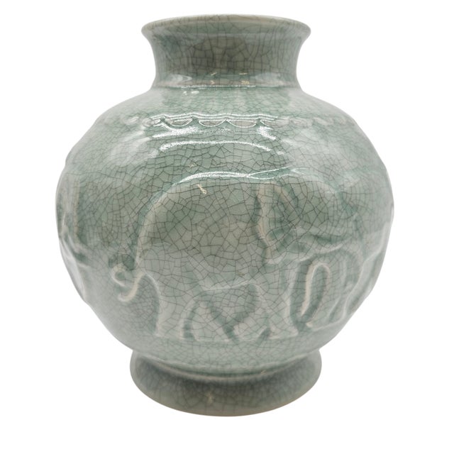 There’s a hushed poetry in celadon—the soft green of jungle mist before dawn. Elephants, gentle and sure, march in quiet...