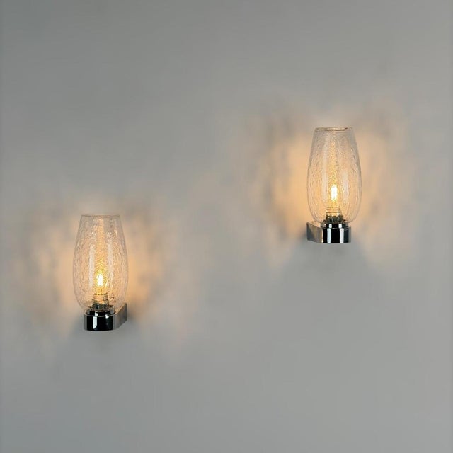 A refined pair of Italian wall sconces from the 1970s, executed in the unmistakable style of Gino Sarfatti and Seguso...