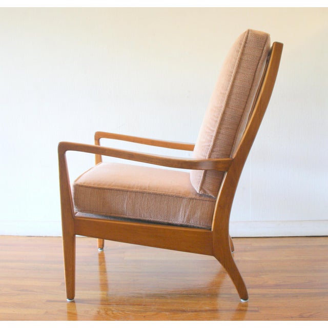 This is a mid century modern Jens Risom style arm lounge chair upholstered in a soft pink striped velvet, with a solid...