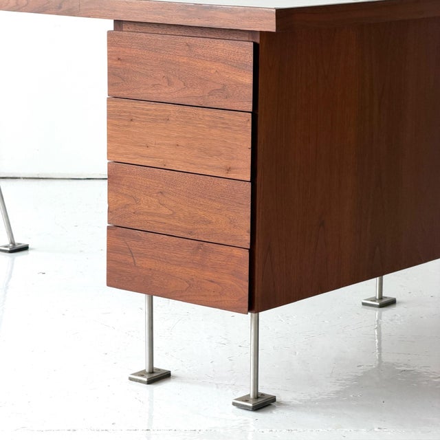 c. 1950s. USA. Walnut frame with white laminate top. Hole on side of table top for lamp to attach. Two sides of drawers