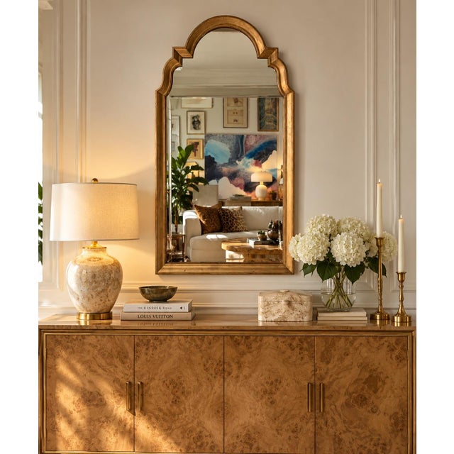 Elegant vintage Hollywood Regency wall mirror by Baker Furniture, featuring a beautifully sculpted architectural arched...