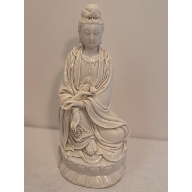 A serene vintage Blanc de Chine porcelain figure of Guanyin, the Buddhist Goddess of Mercy and Compassion. Crafted in...
