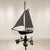 A rare copper weathervane from the early 1900s, featuring a three-dimensional structure depicting a sailboat. The...