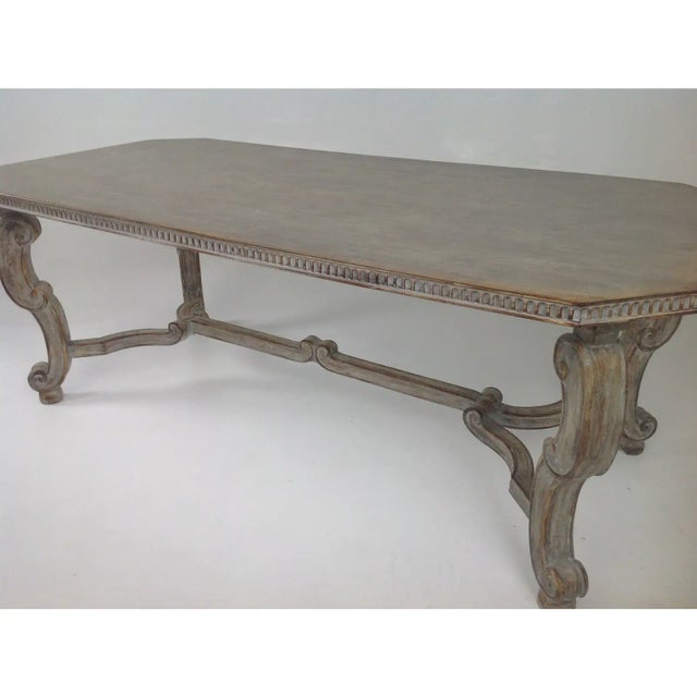 Large dining table with a unique gray ceruse custom finish. Solid top and carved trim and legs. The table is quite unique...