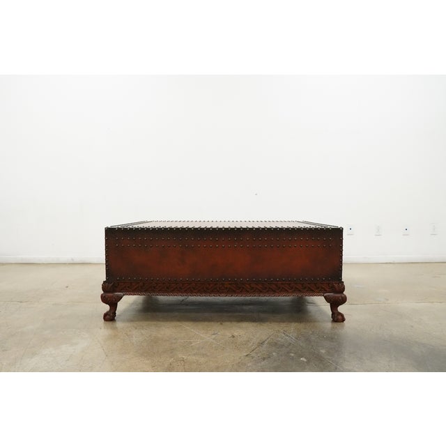 The Dalton Cocktail Table by Polo Ralph Lauren is a striking statement piece inspired by traditional campaign furniture...