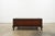 The Dalton Cocktail Table by Polo Ralph Lauren is a striking statement piece inspired by traditional campaign furniture...