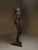 This striking contemporary sculpture depicts a headless male figure in a contrapposto stance, captured with an elegant...