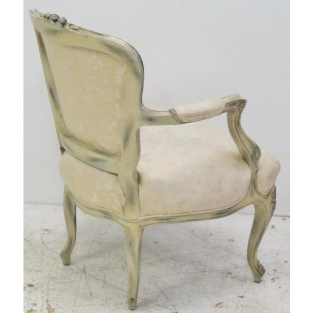 Distressed cream painted carved frame with black highlights. Cream floral upholstery. Light wear to paint. Small tear to...