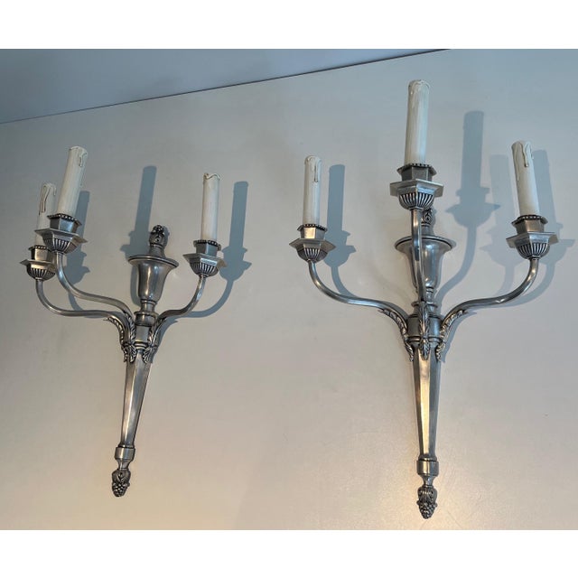 This very beautiful pair of large 3-arm sconces is made of silver-plated metal. The silver has remained in some areas. We...