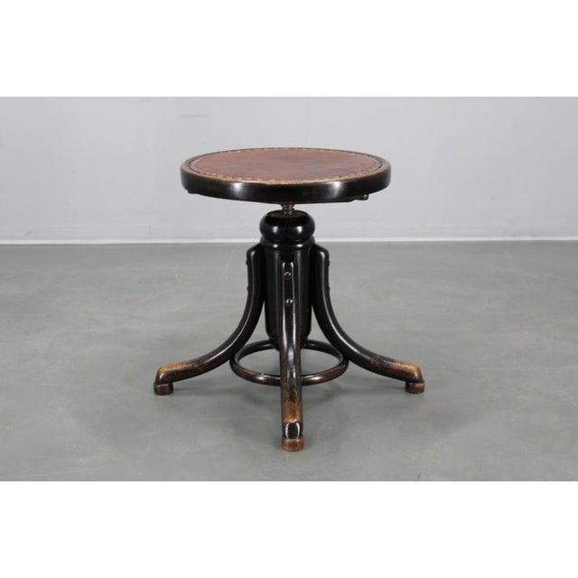 A distinguished vintage piano stool crafted by Thonet in Czechoslovakia during the 1930s, embodying the Art Deco style....