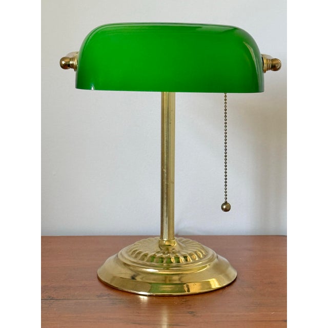 Beautiful banker's desk lamp with green Emeraldite shade and drawstring ball pull. A classic and traditional touch. Please...