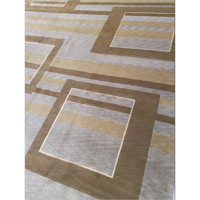 This modern geometric rug features an eye-catching architectural pattern with interlocking rectangular stripes in neutral...