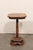 A small-sized English wooden pedestal table from the 19th century. This antique side table from England features an...
