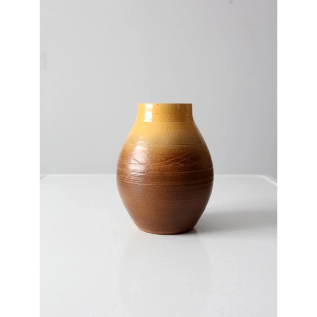 This vintage studio pottery vase features a hand-crafted form with an atmospheric ombré glaze that transitions from...