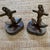 This is a handsome pair of vintage brass nautical anchor bookends, each featuring a dimensional ship’s anchor entwined...