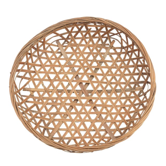 Woven split bamboo circular fish basket with an open weave and narrow multi strand rim. Japan, early 1900’s.