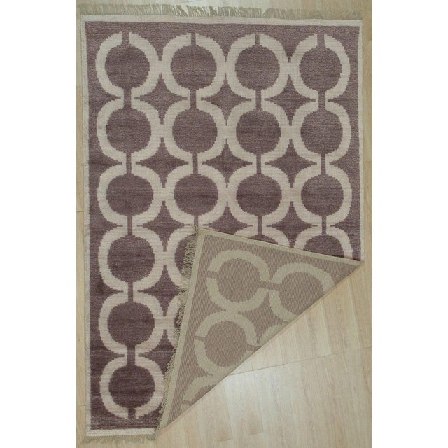 This hand knotted pile rug features a brown earth tone palette and is constructed from a blend of wool and bamboo silk. As...