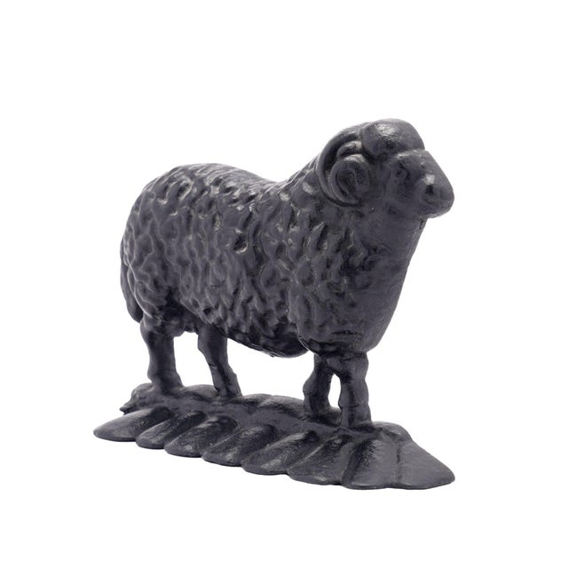 Painted English Victorian cast iron ram doorstop with hollow back. The ram is right facing and has a full, textured coat...