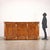 Restoration sideboard resting on a plinth base, the front is marked by three paneled doors alternating with pilasters that...